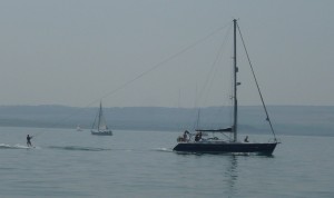 water skiing behind a yacht